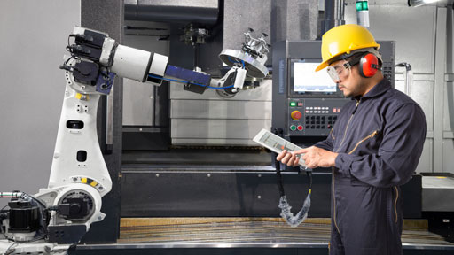 Image of Frontline worker in front of a robotic arm